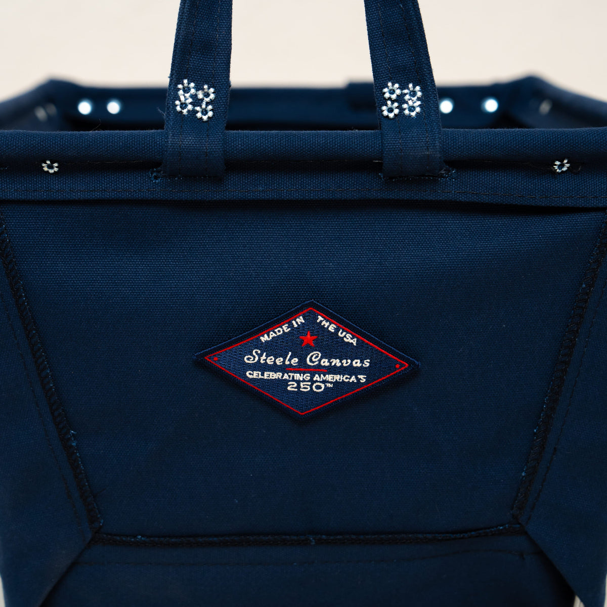 Navy blue basket with a brand logo on a light gray background