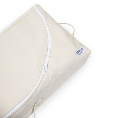 Beige pillow with white zipper on a white background