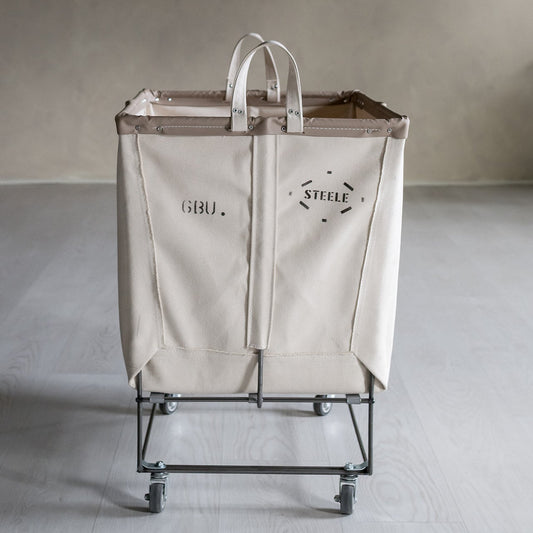 Beige laundry cart with 'Steele' branding on a neutral background
