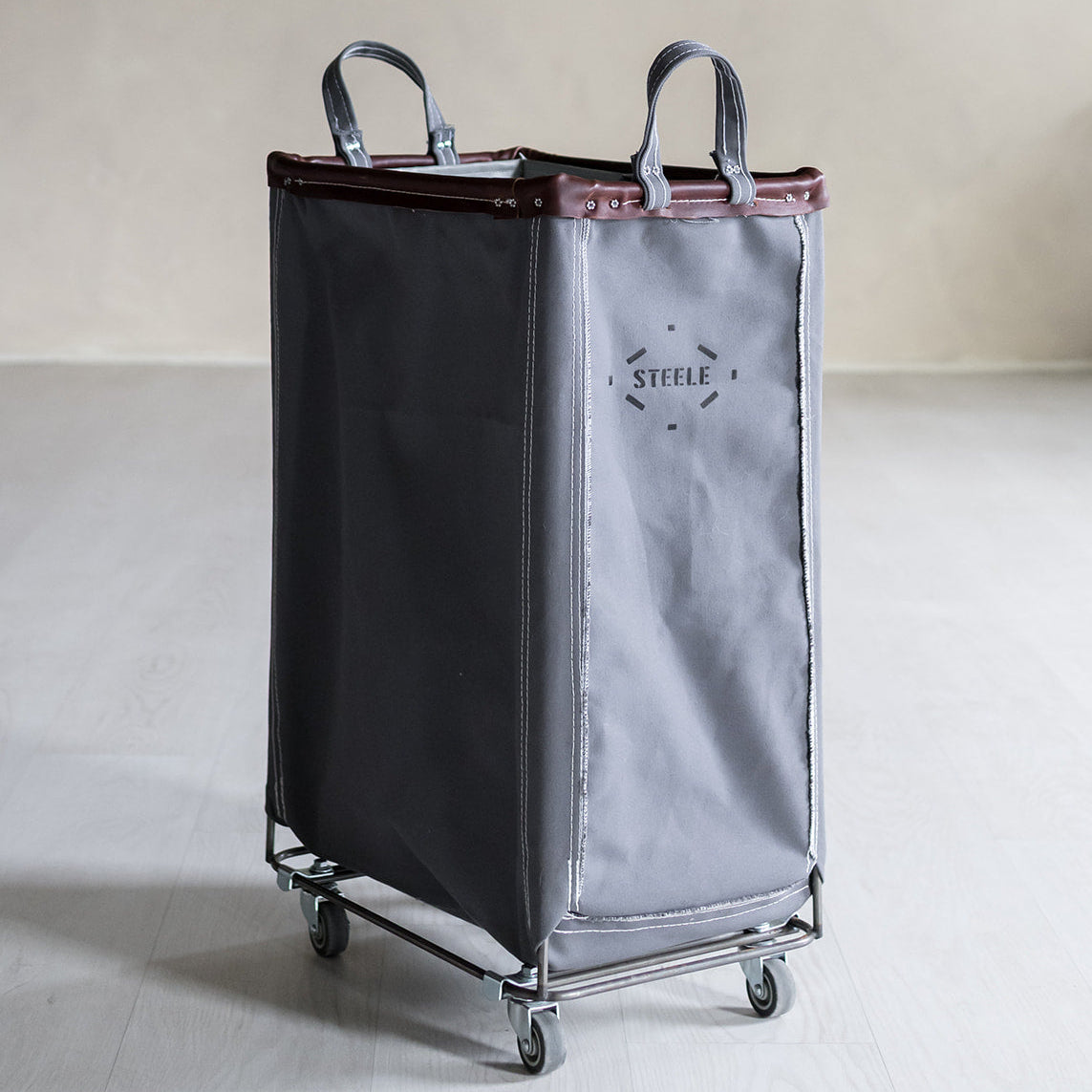 Two-toned laundry cart with a visible brand logo on a neutral background