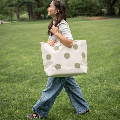 Woman walking outdoors with a polka dot tote bag
