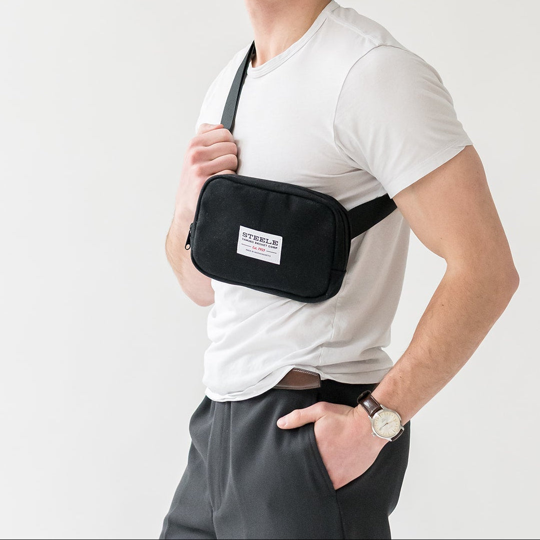 Man wearing a black waist bag on a white background