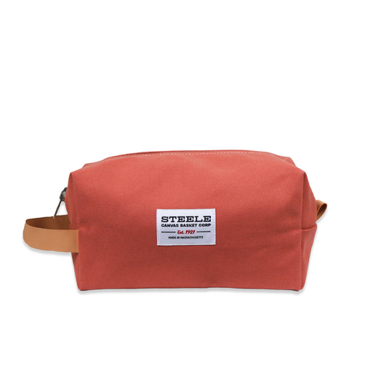 Red toiletry bag with a visible brand label on a white background