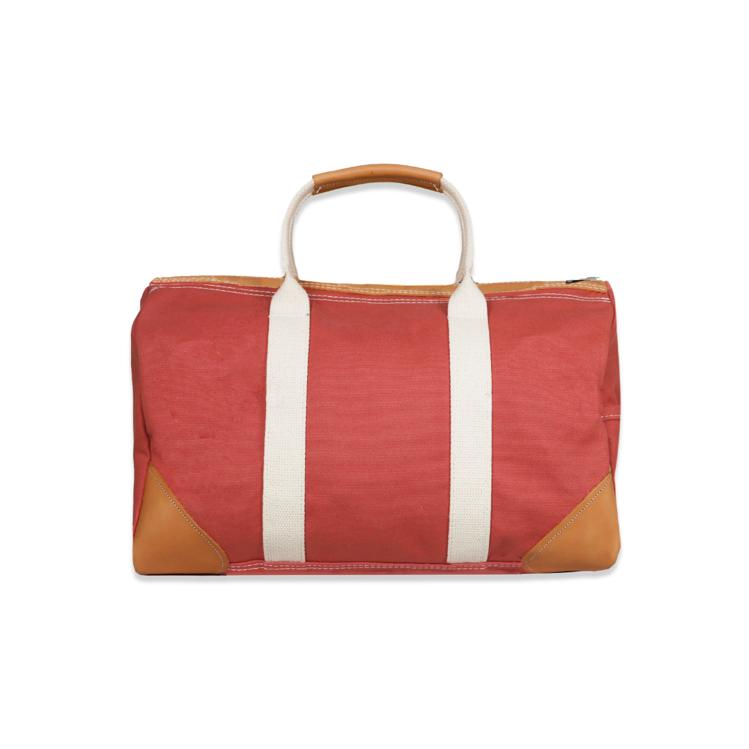 Red bag with white straps and brown accents on a white background