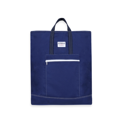 Navy blue tote bag with a white zipper pocket on a white background