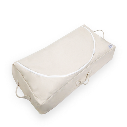 Beige wedge pillow with white zipper on a white background