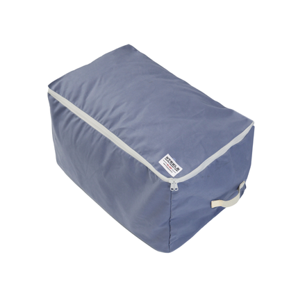 A dusty blue canvas storage bag with light gray trim and a small white brand label, shown on a plain white background.