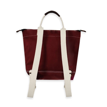 Maroon tote bag with white straps on a white background