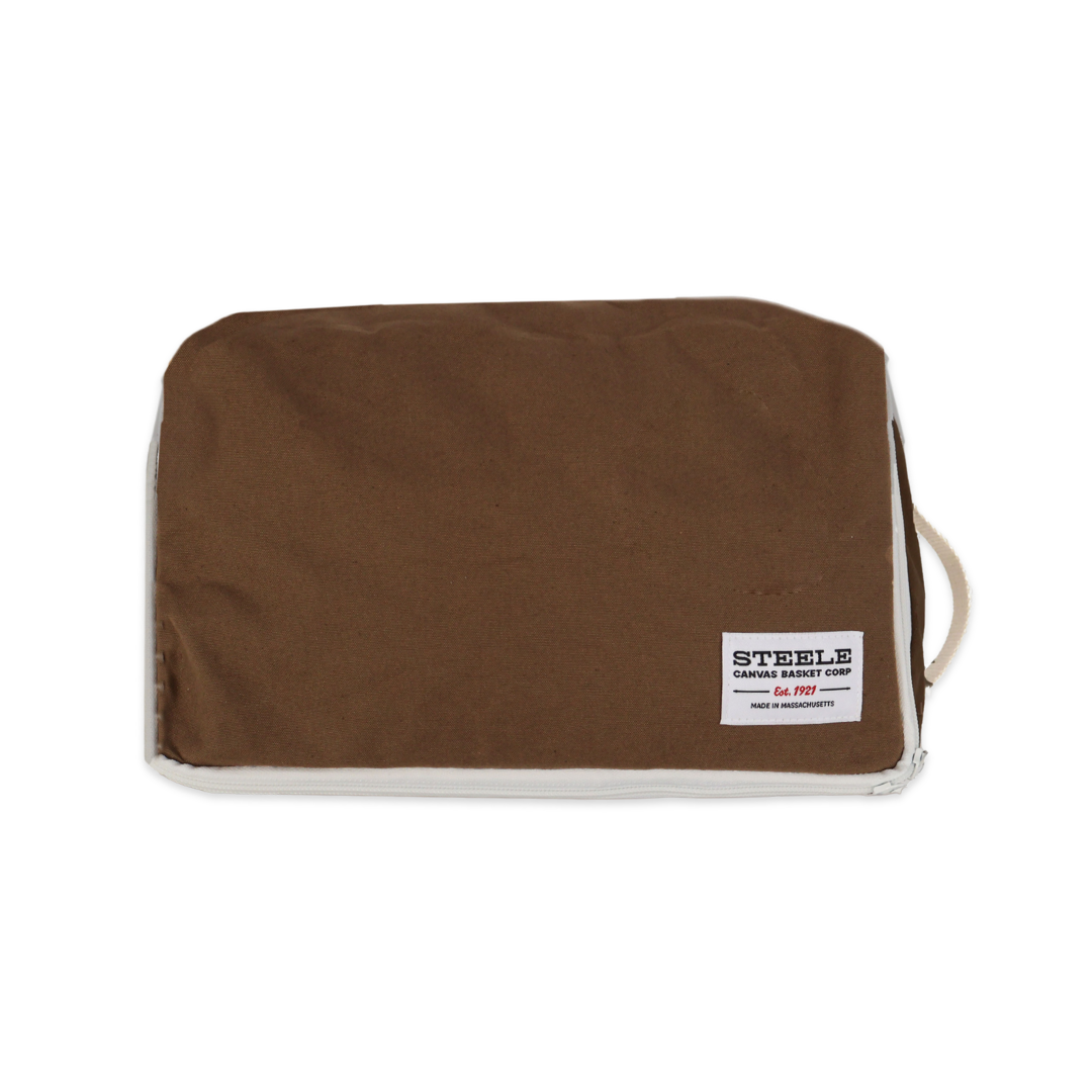 A brown canvas sleeve or pouch with a white stitched border and a white brand label reading 'STEELE' on a plain white background.