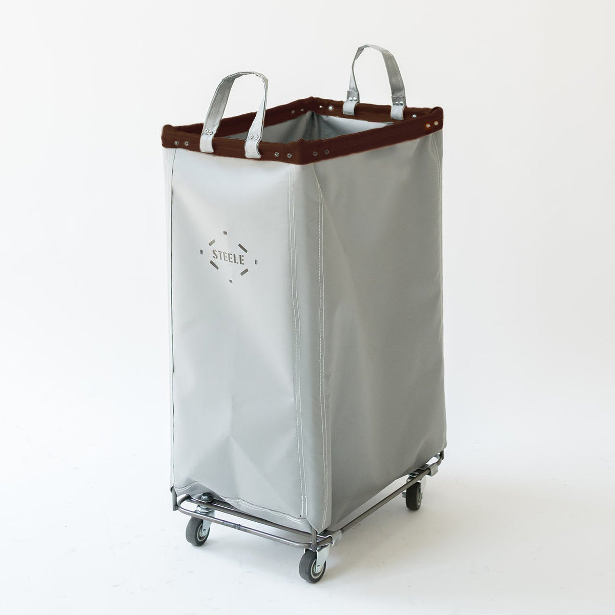 A light gray vinyl laundry hamper with a dark brown leather trim along the top edge, two handles, and a steel wheeled base, shown on a plain white background.